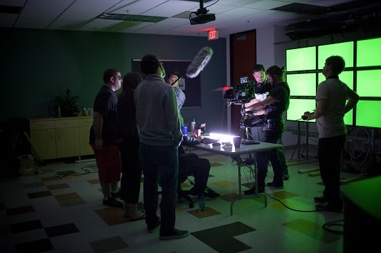 Film Connection student Sean McCarthy working with the art department on the set of a film
