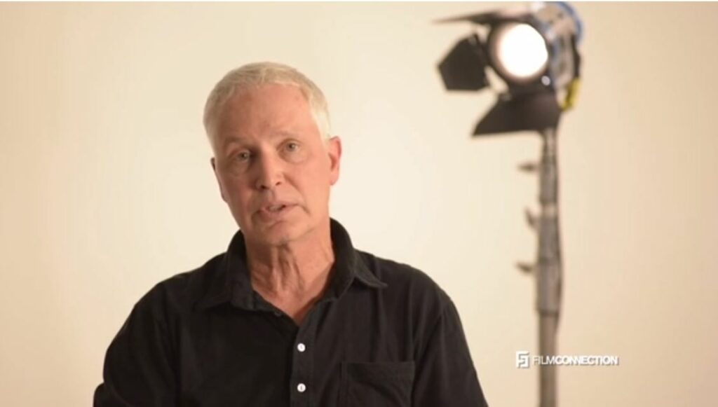 John Raffo Film Connection Mentor on film set in front of light