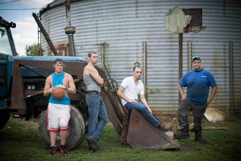 A still shot from Medora, featuring four young men in a rural setting.