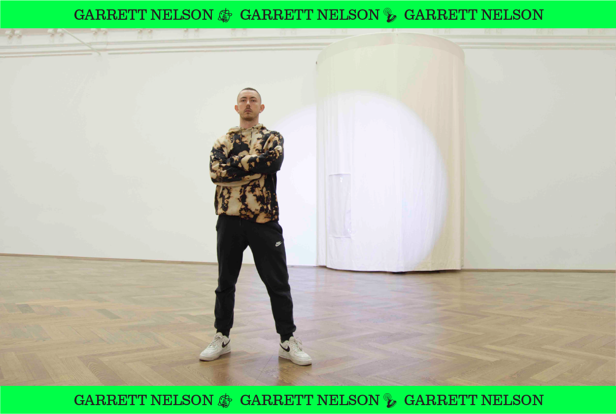 Image of Garrett Nelson standing in an empty room.